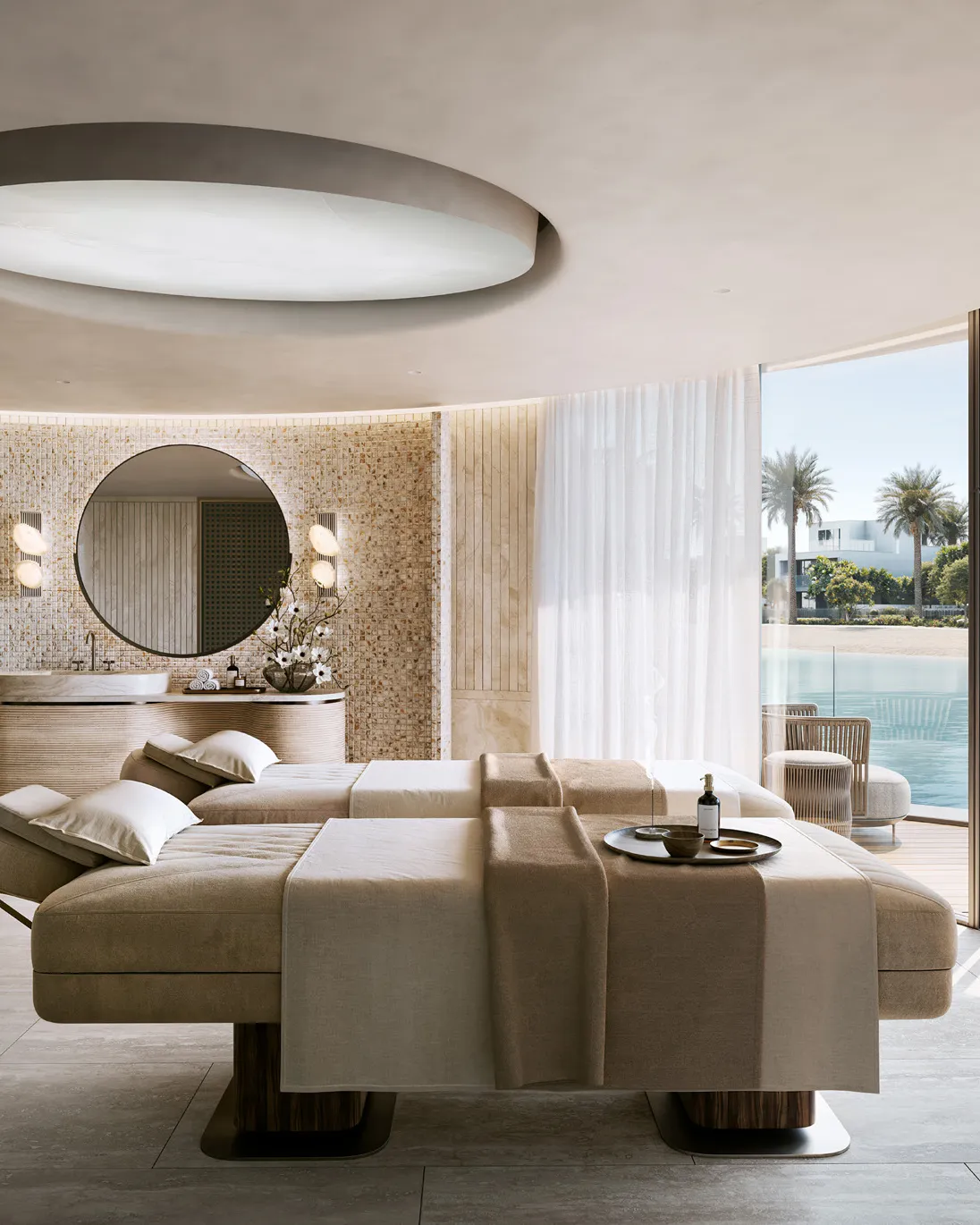 Twin treatment beds in a spa room opening onto the lake